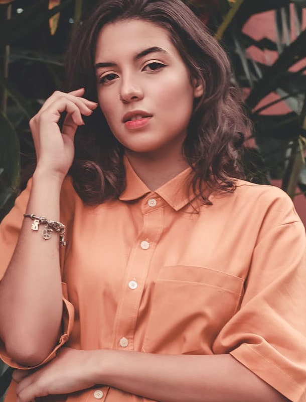 A girl in an orange blouse