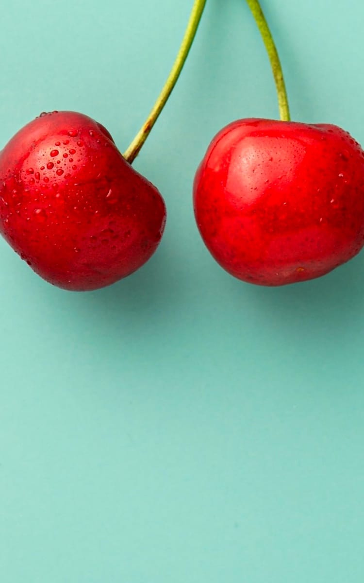 A cherry on a green background